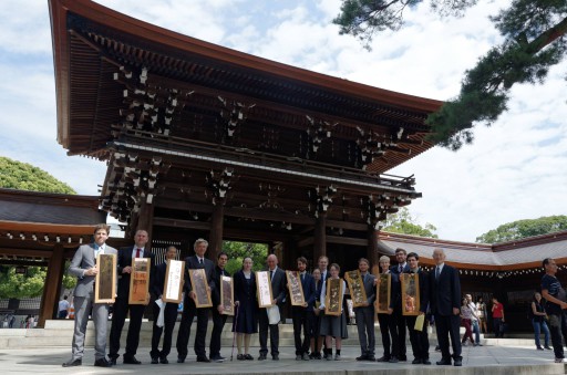 Inaba sensei with group members holding meiji shrine roof tiles .jpg